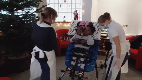 Twins learning to stand