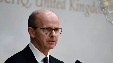 Getty Images Sir Jeremy Fleming delivering an address in Singapore in 2019