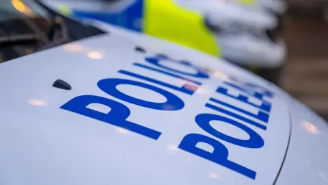 The bonnets of several Police Scotland vehicles.