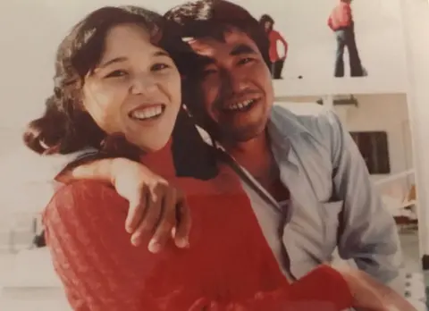 Teruaki Masumoto A picture showing Teruaki Masumoto as a young man, with an arm round his sister. Both of them are laughing