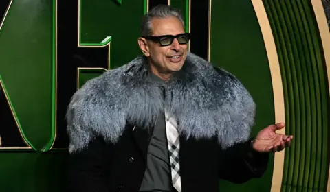 Getty Images Jeff Goldblum wore a long black coat and a fur shawl to the London premiere of the film Wicked