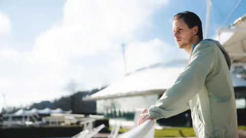 Kirsty Jayne Russell A man leaning on a white fence 