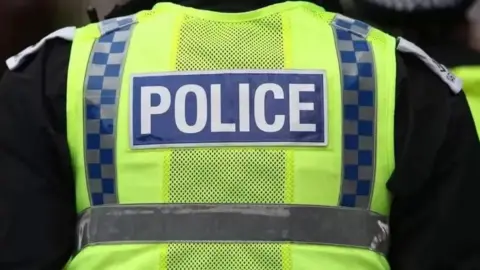 PA Media View of back of police officer wearing uniform