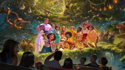 Disney A scene from the new Encanto ride is shown in an artist impression. Characters from the Disney Animation film are seen performing as a ride vehicle filled with people passes by