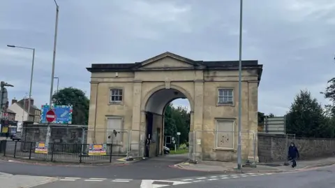 Matt Emmett Roadside view of the front of the two-storey arch, with four windows, two of which are blocked out