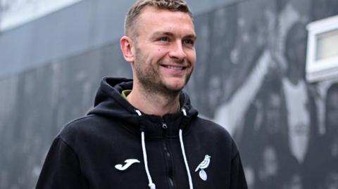 Ben Gibson in a Norwich tracksuit