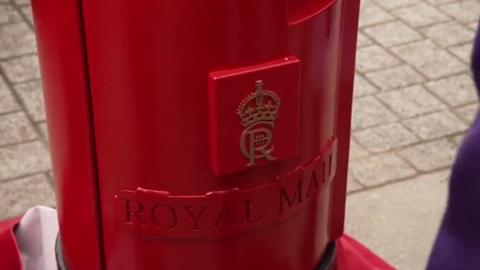 A red post box with King Charles' cypher on it, and "Royal Mail" embossed below