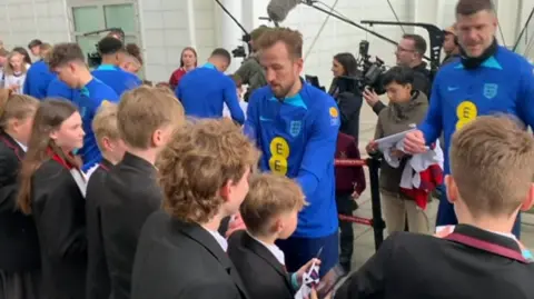 Harry Kane with school students