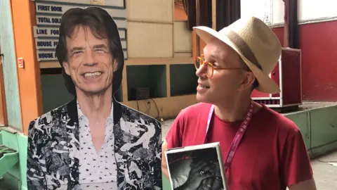 John Devine/BBC Norman Jacobs with cut out of Mick Jagger