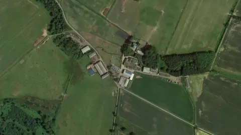 Google Aerial view of a farm surrounded by fields