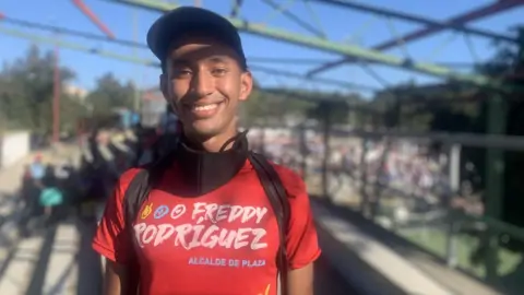 Bryan Zambrano poses for a photo at a pro-government campaign