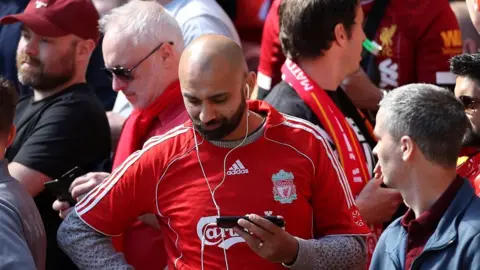 Reuters fans check phones