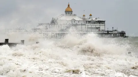 PA Media Waves crash near the pier in Eastbourne, East Sussex, as winds of up to 70mph are expected along the coast during the next 36 hours along with up to 90mm of rain as Storm Francis hit the UK.