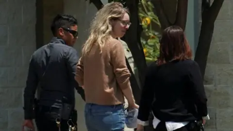 Theranos founder Elizabeth Holmes arrives to begin serving her prison sentence for defrauding investors in the failed blood-testing startup, at the Federal Prison Camp in Bryan, Texa