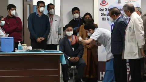 Getty Images A sanitation worker became the first Indian to receive a Covid vaccine at the All India Institute of Medical Science (AIIMS) in New Delhi in January 16, 2021.