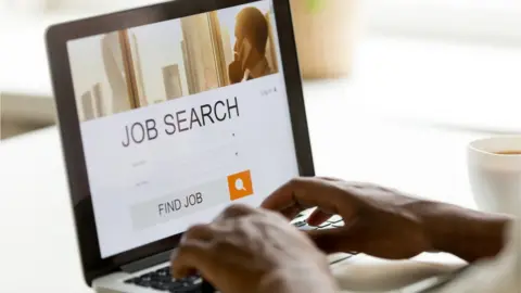 Getty Images Person searching for jobs on a computer