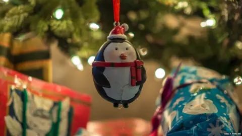 Kelly Mercer Baubles and presents on a Christmas Tree (Image: Kelly Mercer/Flickr)