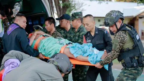 EPA A Thai soldier is carried on to an ambulance by other soldiers on a stretcher