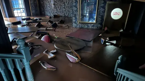 Andrea Shull Picture of Shull's restaurant in brown water, tables and chairs underwater 