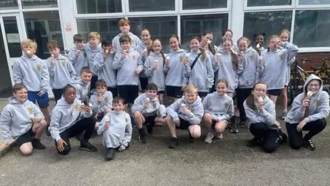 St Margaret Mary’s Catholic Junior School Group of children wearing grey hoodies at St Margaret Mary’s Catholic Junior School