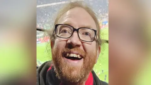 Family handout Smiling man in glasses 