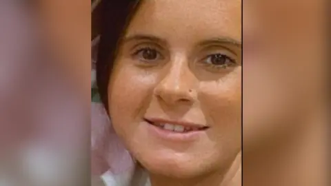 Avon and Somerset Police A young woman's face is seen close up. She has dark hair and eyes and is smiling.
