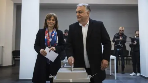 EPA A man with his wife casts a ballot