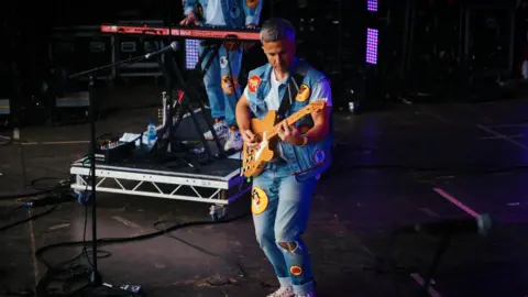 The Hoosiers on stage - one member at the keyboard and the other on a Telecaster guitar with a natural maple finish.