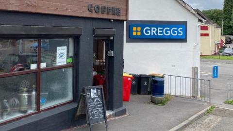 Coffee shop and Greggs shop signs