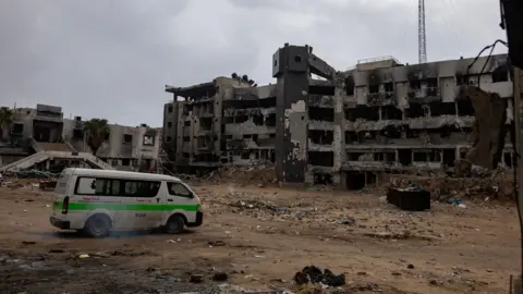 EPA A van parked outside al-Shifa hospital in Gaza, which has been completely destroyed.