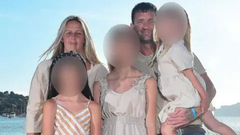 Facebook Man and woman hold three children who have their faces blurred