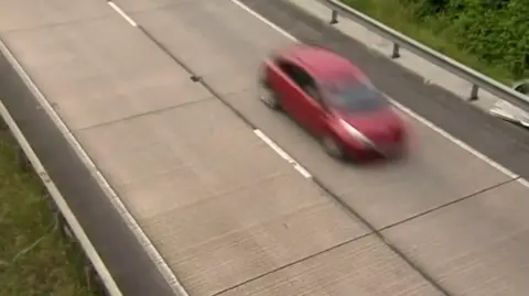 BBC A car on the concrete road surface of the A180 in Lincolnshire