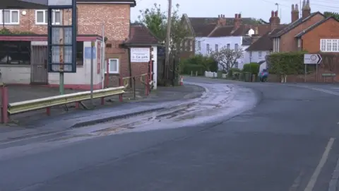 Peter West A water leak coming from a road and running downhill.