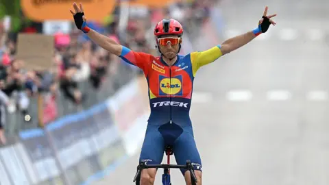 Carlos Verona celebrates after crossing the finish line.