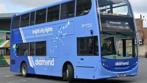 A Go North East bus. The vehicle has a blue livery with Durham Diamond written on the side.