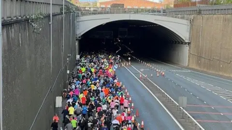 Runners going under the Kingsway Tunnel.