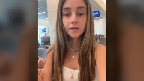 Tara Kehidi filming herself while sitting at airport