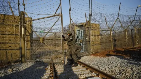 Getty Images South Korean soldiers open the gates at the border into North Korea (30 Nov 2018)