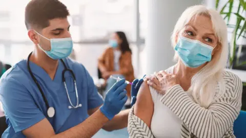 Getty Images Woman being vaccinated