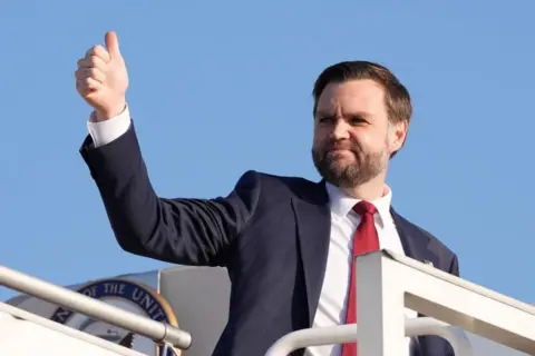 Pool/Reuters Vice President JD Vance gestures with his thumb raise as he boards Air Force Two, after peace talks with Iran in Islamabad, Pakistan.