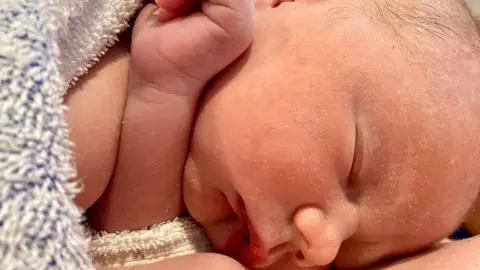 Family handout A sleeping newborn baby