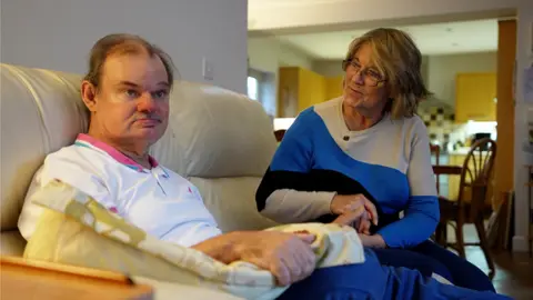 Andrew and Margaret sitting on the couch at home