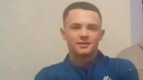 Harry Gilbertson, wearing a blue sports top, looks ahead in a photo