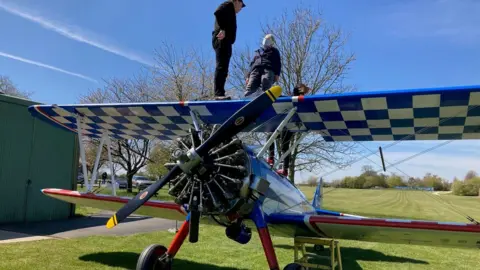Macmillan Cancer Support Lyn Mitchell getting strapped in