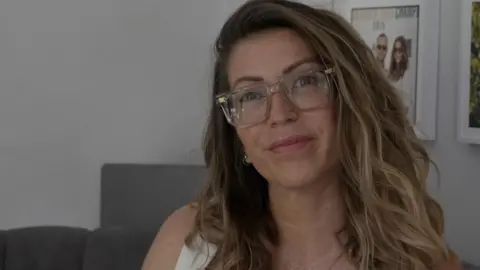 Selina Moss-Davies looking straight at the camera and wearing glasses