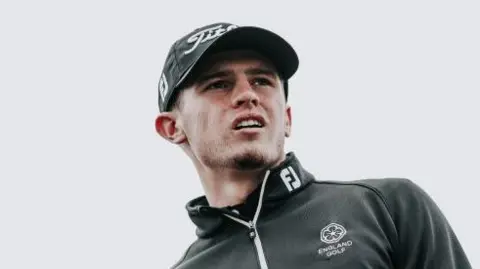 Getty Images Tyler Weaver looks away from the camera. He wears a black cap and black jumper.