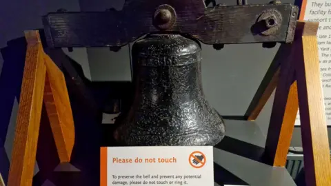 BBC/Mick Lunney A heavy, black metal bell mounted in a wooden frame, made around 1880