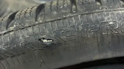 Marie McCallum A black car tyre has a hole in it caused by a pothole 
