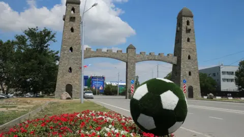 Getty Images : A football flowerbed near an arch at the entrance to the Grozny Airport in Grozny, Russia's Chechen Republic, before the arrival of Egypt's national football team ahead of the FIFA World Cup Russia 2018.