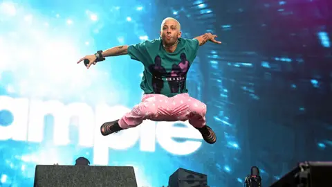 Dave J Hogan/Getty Images Example leaps into the air from the Obelisk stage at Latitude